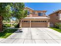 Inviting two-story home with a three-car garage and well-maintained landscaping and driveway at 9440 Grenville Ave, Las Vegas, NV 89134