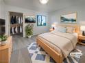Bright bedroom featuring a walk-in closet, a queen bed, and modern decor at 950 Seven Hills Dr # 217, Henderson, NV 89052