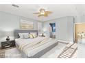 Serene bedroom with soft lighting, comfortable bed, and ensuite bathroom access, creating a relaxing retreat at 9685 Stonily Ln, Las Vegas, NV 89178