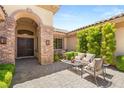 Charming courtyard with outdoor seating and a stone facade at 9747 Cathedral Pines Ave, Las Vegas, NV 89149