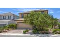 Two story home featuring a paver driveway, desert landscaping, and mature shade trees at 9785 W Meranto Ave, Las Vegas, NV 89178