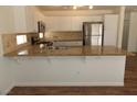 Bright kitchen with granite counters, stainless steel appliances, and wood floors at 1018 Sun Poppy Ave, Las Vegas, NV 89123