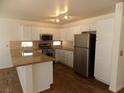 Bright kitchen with stainless steel appliances, granite countertops, and white cabinetry at 1018 Sun Poppy Ave, Las Vegas, NV 89123