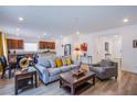 Open floorplan living room with hardwood floors, contemporary furniture, and lots of natural light at 10435 Rose Palisade St, Las Vegas, NV 89141