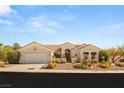 Charming one-story home boasts a three car garage, tile roof, desert landscaping, and inviting curb appeal at 10548 Findlay Ave, Las Vegas, NV 89134