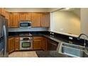 The kitchen has stainless steel appliances and granite countertops at 11404 Belmont Lake Dr # 103, Las Vegas, NV 89135