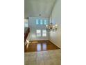 Open-plan living area with tall ceilings and a decorative chandelier at 11404 Belmont Lake Dr # 103, Las Vegas, NV 89135