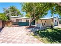 Private backyard featuring a tiled patio area, mature trees, and ample space for outdoor enjoyment at 1904 Fontenelle St, Las Vegas, NV 89102