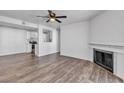 Spacious living room with hardwood floors, a fireplace, and open view to the kitchen, creating an inviting atmosphere at 220 Mission Catalina Ln # 208, Las Vegas, NV 89107