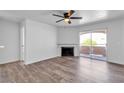 Bright living room with hardwood floors, a ceiling fan, and a fireplace, providing a comfortable living space at 220 Mission Catalina Ln # 208, Las Vegas, NV 89107