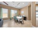 Bright dining room featuring tile flooring, large windows, and a modern chandelier over the table at 2279 Pacini Ct, Henderson, NV 89052
