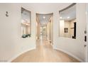 Inviting entryway with decorative wall cutouts, neutral paint, and tile flooring leads to the living areas at 2279 Pacini Ct, Henderson, NV 89052