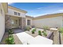 Inviting entrance with stone details, a well-manicured yard and attractive walkway at 2899 Brook Trout Ct, Henderson, NV 89052