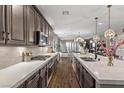 Bright open kitchen features a gas range, stainless steel appliances, and an oversized island for dining at 3 Vicolo Sebino, Henderson, NV 89011