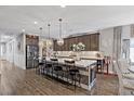 Beautiful kitchen featuring a large island, stainless steel appliances, and luxury vinyl plank flooring at 3 Vicolo Sebino, Henderson, NV 89011