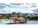 Beautiful aerial view of lakefront community showcasing lagoon, lush greenery and surrounding mountain views at 3151 Soaring Gulls Dr # 1066, Las Vegas, NV 89128