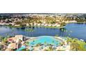 Picturesque aerial view of a lakefront community with a sandy beach lagoon and swaying palm trees at 3151 Soaring Gulls Dr # 1066, Las Vegas, NV 89128