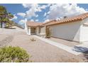 Front exterior view of house with desert landscaping leading to the entrance at 317 Brent Ct, Henderson, NV 89074