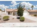 Charming single-story home with a well-manicured yard and inviting entryway at 317 Brent Ct, Henderson, NV 89074