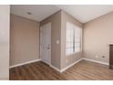 Cozy room features wood floors, a window, and a white door at 317 Brent Ct, Henderson, NV 89074