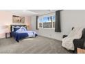 Comfortable bedroom with plush carpeting, a large window, and stylish decor at 3208 Alcoa Ave, Las Vegas, NV 89102