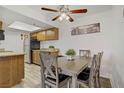 Kitchen and dining area with modern appliances, wood cabinets, and hardwood floors at 4200 S Valley View Blvd # 1120, Las Vegas, NV 89103