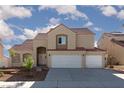 Charming two-story house showing red tile roof, desert landscaping, and a convenient two-car garage at 426 Lost Trail Dr, Henderson, NV 89014