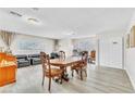 Bright and airy dining room featuring stylish flooring, neutral walls and modern recessed lighting at 465 E Robindale Rd, Las Vegas, NV 89123