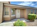 Inviting front entrance with a white door, manicured landscaping, and natural light at 4841 Raw Umber Ct, Las Vegas, NV 89131