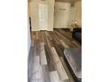 Entryway leading to the open living room with modern plank flooring at 5000 Indian River Dr # 483, Las Vegas, NV 89103
