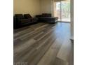 Bright living room with plank flooring and sliding glass doors to a balcony at 5000 Indian River Dr # 483, Las Vegas, NV 89103