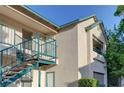 Exterior of a tan building with blue railings and a walkway at 5161 Lindell Rd # 206, Las Vegas, NV 89118