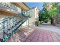Exterior of a tan building with blue railings and a walkway at 5161 Lindell Rd # 206, Las Vegas, NV 89118