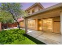 A well-maintained backyard featuring plush green grass and a covered patio, offering an ideal relaxation space at 5568 Table Top Ln, Las Vegas, NV 89135