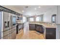 Spacious kitchen with stainless steel appliances, dark cabinets, and a convenient breakfast bar for casual dining at 5732 Hornbrook St, North Las Vegas, NV 89031
