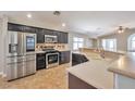 Well-appointed kitchen with stainless steel appliances, dark cabinetry, and tile backsplash at 5732 Hornbrook St, North Las Vegas, NV 89031