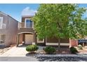 Inviting two-story home featuring a private balcony, driveway, mature landscaping, and a porte-cochere at 6313 Pangea Ave, Las Vegas, NV 89139