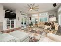 Bright living room featuring a ceiling fan, a large window, and access to the backyard at 6617 Golden Bit Ave, Las Vegas, NV 89131