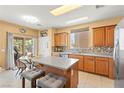 Charming kitchen featuring a large island, ample cabinet space, and stainless steel appliances at 7032 Wonderberry St, Las Vegas, NV 89131