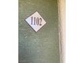 Door 1102 on a green textured wall with a tan border at 8101 W Flamingo Rd # 1102, Las Vegas, NV 89147