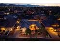 Aerial view of the home at dusk, highlighting the well-manicured landscaping and neighborhood at 8149 Villa De La Playa St, Las Vegas, NV 89131
