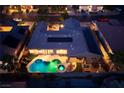 Aerial view of the property showcasing the spacious backyard, sparkling pool, covered patio, and solar panels at 8149 Villa De La Playa St, Las Vegas, NV 89131