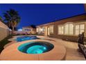 Relaxing backyard with a pool, spa, and lush landscaping, creating a private oasis at 8149 Villa De La Playa St, Las Vegas, NV 89131