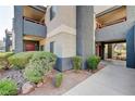 View of the apartment complex with sidewalk and green landscaping around the building at 8600 W Charleston Blvd # 1059, Las Vegas, NV 89117