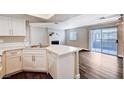 Open-concept kitchen with white cabinets and countertops flowing into the living area at 8600 W Charleston Blvd # 1059, Las Vegas, NV 89117