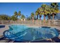 Refreshing community pool surrounded by lush palm trees, offering a relaxing oasis at 8768 Tom Noon Ave # 101, Las Vegas, NV 89178