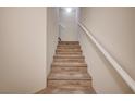 Carpeted staircase leading to the upper levels, providing a smooth transition between floors at 8768 Tom Noon Ave # 101, Las Vegas, NV 89178