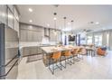 Modern, spacious kitchen with stainless steel appliances and a large kitchen island with barstool seating at 879 Klamath Springs St, Henderson, NV 89011