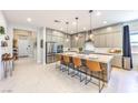 Bright kitchen featuring a large island with seating, stainless appliances, and ample cabinet space at 879 Klamath Springs St, Henderson, NV 89011