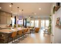Open-concept kitchen with a large island, pendant lighting, and modern appliances at 879 Klamath Springs St, Henderson, NV 89011